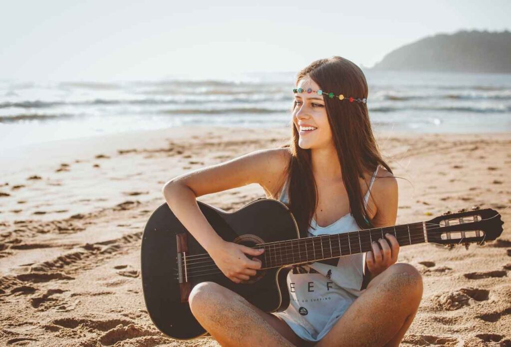 A beautiful girl playing guitar at Copper Beach