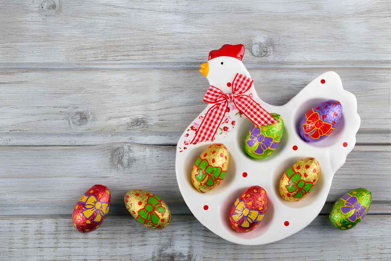 Plate filled with colorful eggs arranged in the shape of a chicken.